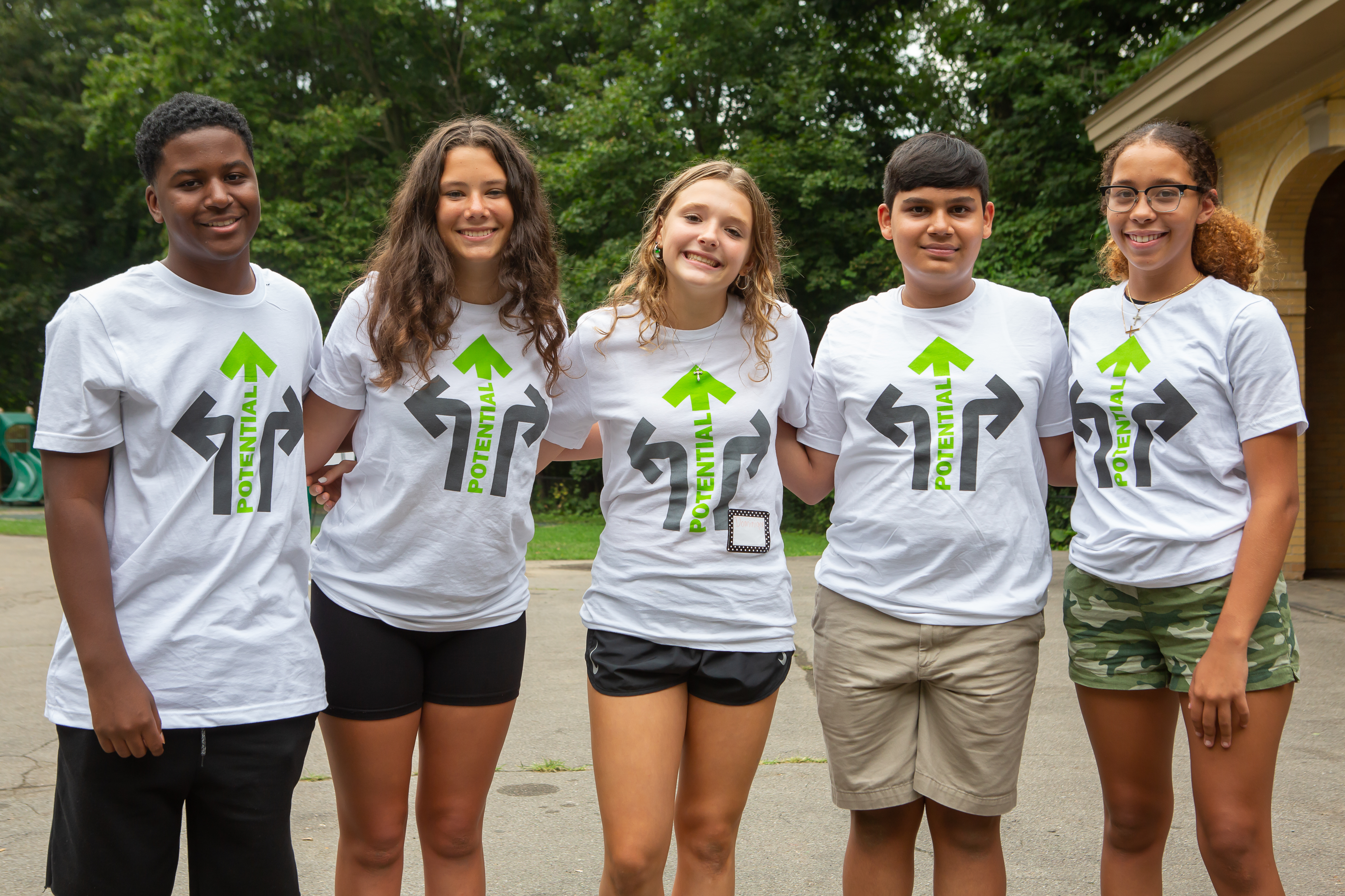 Students standing together with Crossroads t-shirts on